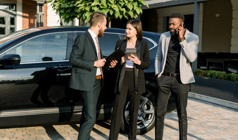 business people with black car in the background